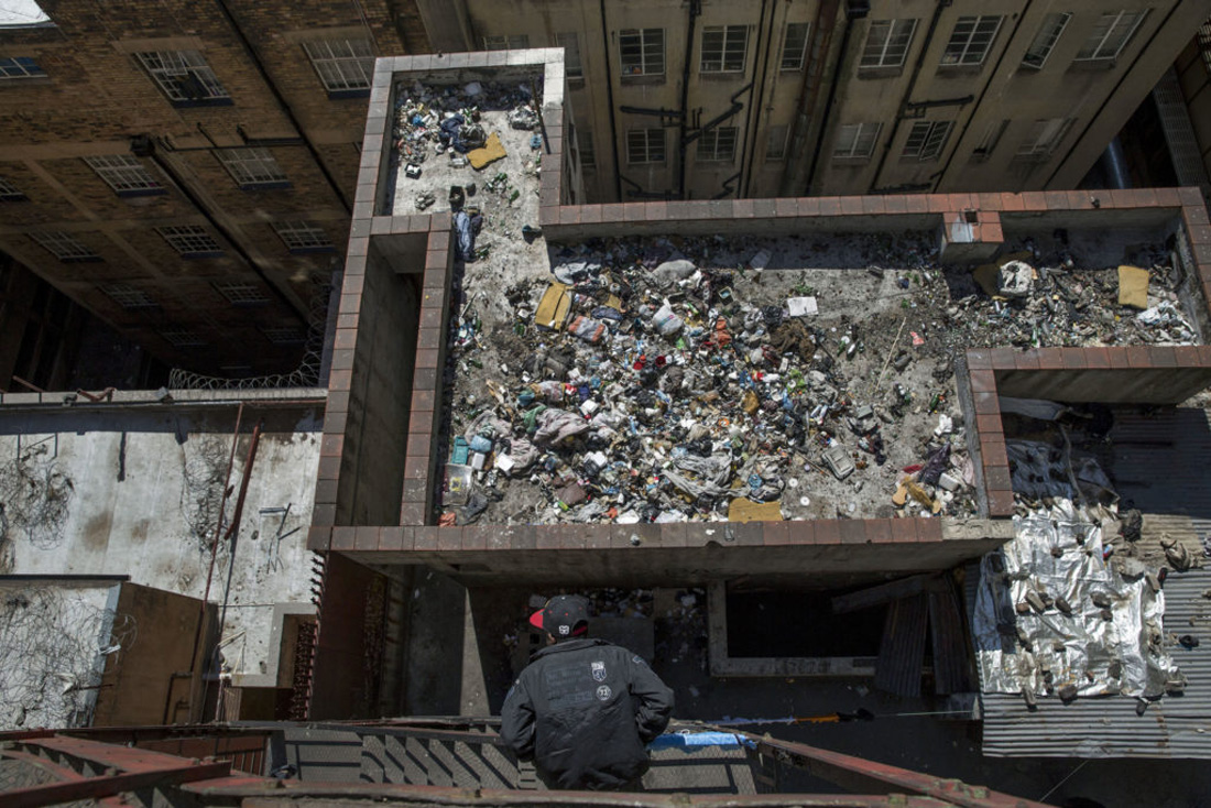 JOHANNESBURG, SOUTH AFRICA - AUGUST 2: Rubbish filled roof at one of the derelict 'hijacked' building that houses African migrants, in Johannesburg's Inner city. The neglected building had several fires, and does not have running water and electricity. August 2, 2015 in Johannesburg, South Africa. Thousands of African migrants are looking south, and arriving in Johannesburg, one of Africas most affluent cities. Many end up living in derelict buildings in Johannesburgs inner city, a place known for its high level of crime, poverty, and unemployment. The properties have been abandoned by their owners and are run by slum lords that collect rent from the poor migrant workers. In most cases there is no electricity or running water, leaving the residents to live in sub-humane conditions in a disease infested environment. It is estimated that South Africa has over 2 million illegal immigrants from other African countries. (Photo by Jonathan Torgovnik/Getty Images Reportage)