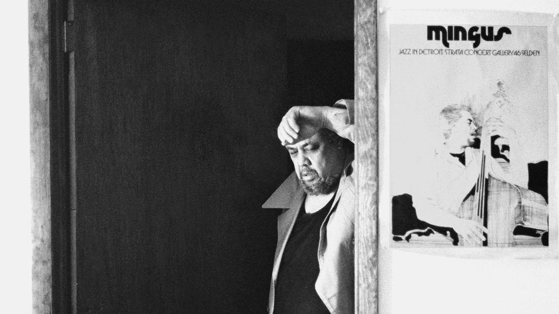 Charles Mingus poses next to a poster for his six nights of performances at the Strata Concert Gallery in Detroit in 1973. A recording of one of those nights has just been released.